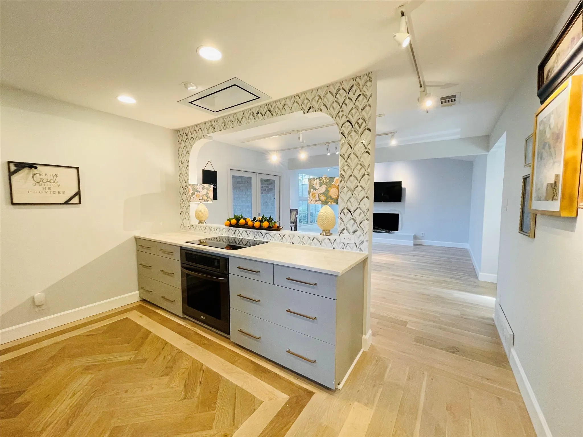 Herringbone wood-finish flooring with a border inlay