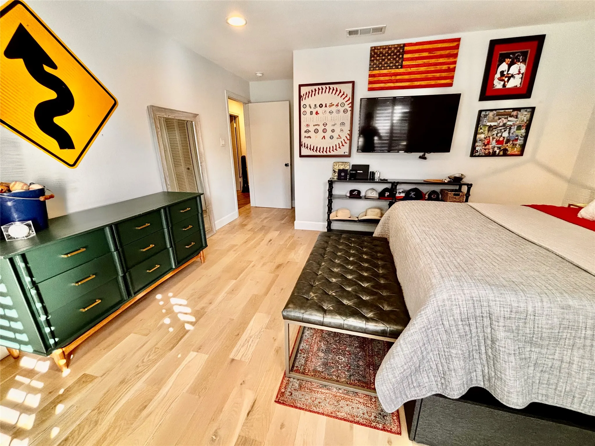 Light wood-finish flooring throughout, recessed lighting, and a white wall finish
