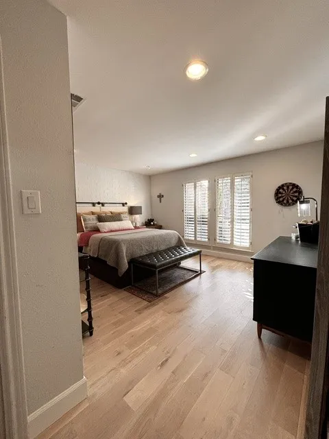Light wood-finish flooring with recessed ceiling lighting