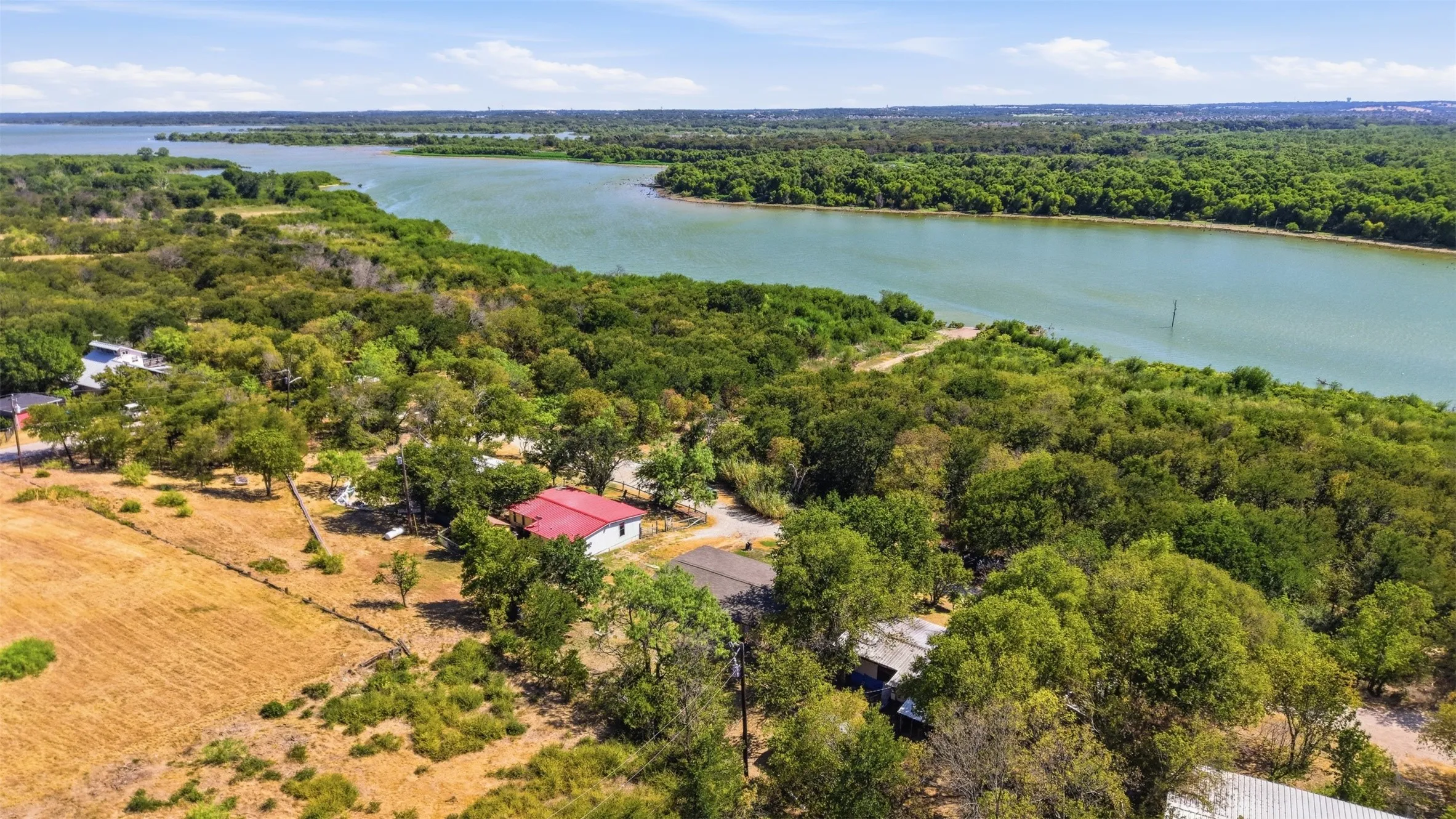 Waterfront property featuring extensive mature trees and natural landscaping