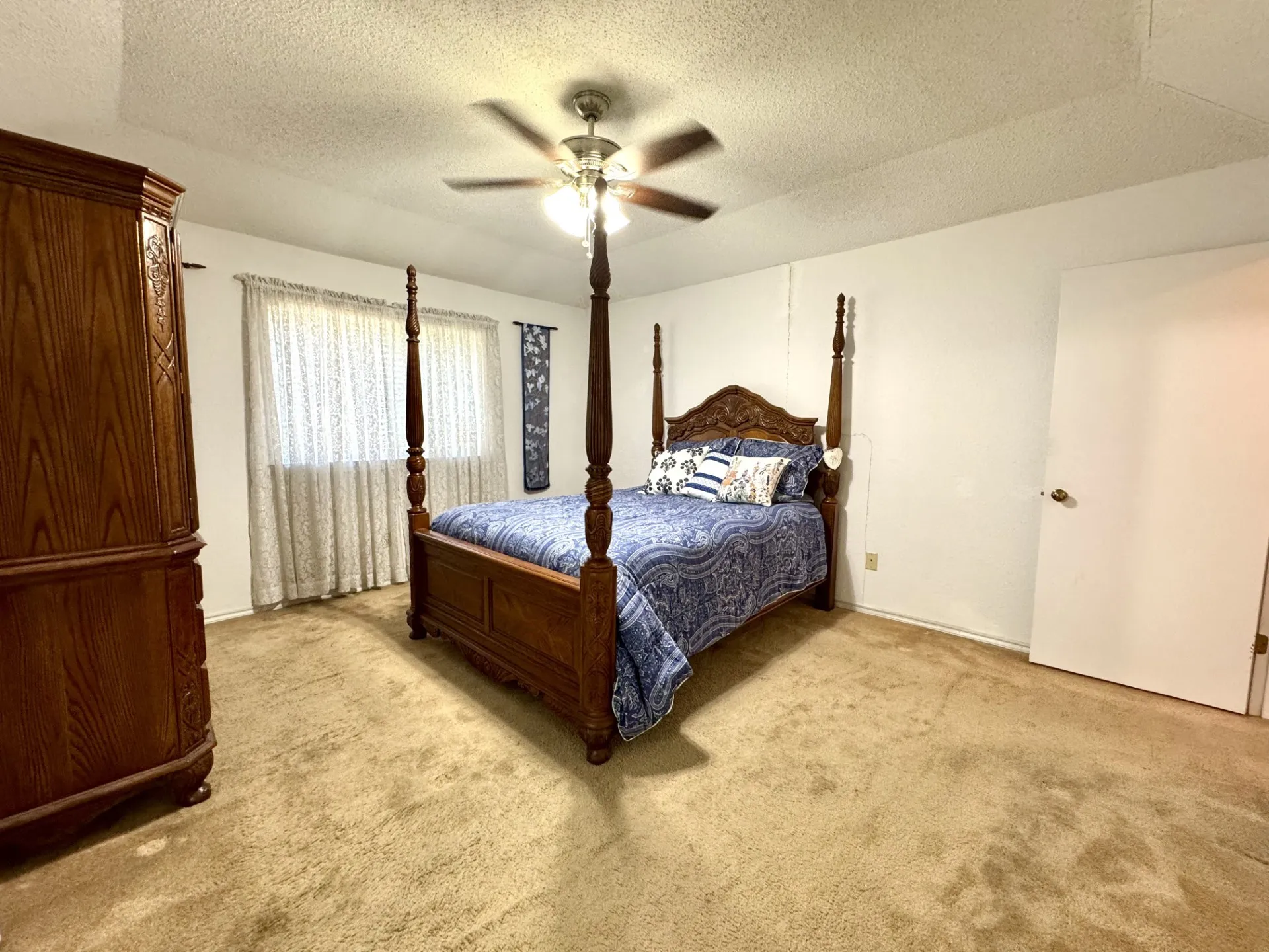 Primary Bedroom: carpeted flooring and vaulted ceiling with fan. Furnishings may convey with acceptable offer!
