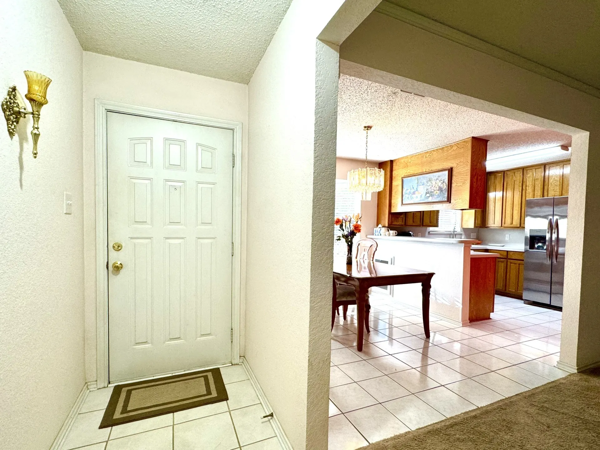 Front Door foyer with six-panel entry door opens to the living, kitchen, and dining areas. There's also a front glass storm door (not shown).