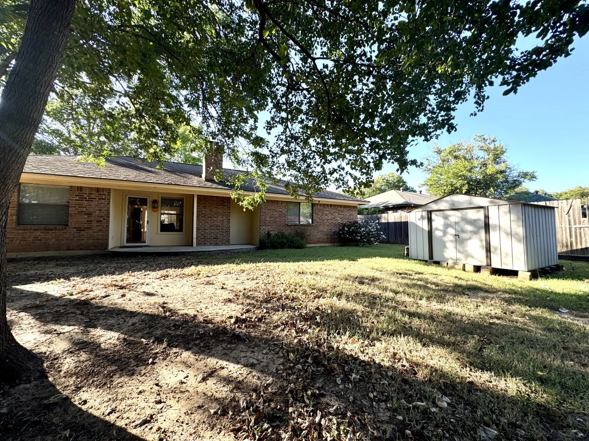 Private Backyard: covered patio, storage shed, and a privacy fence.