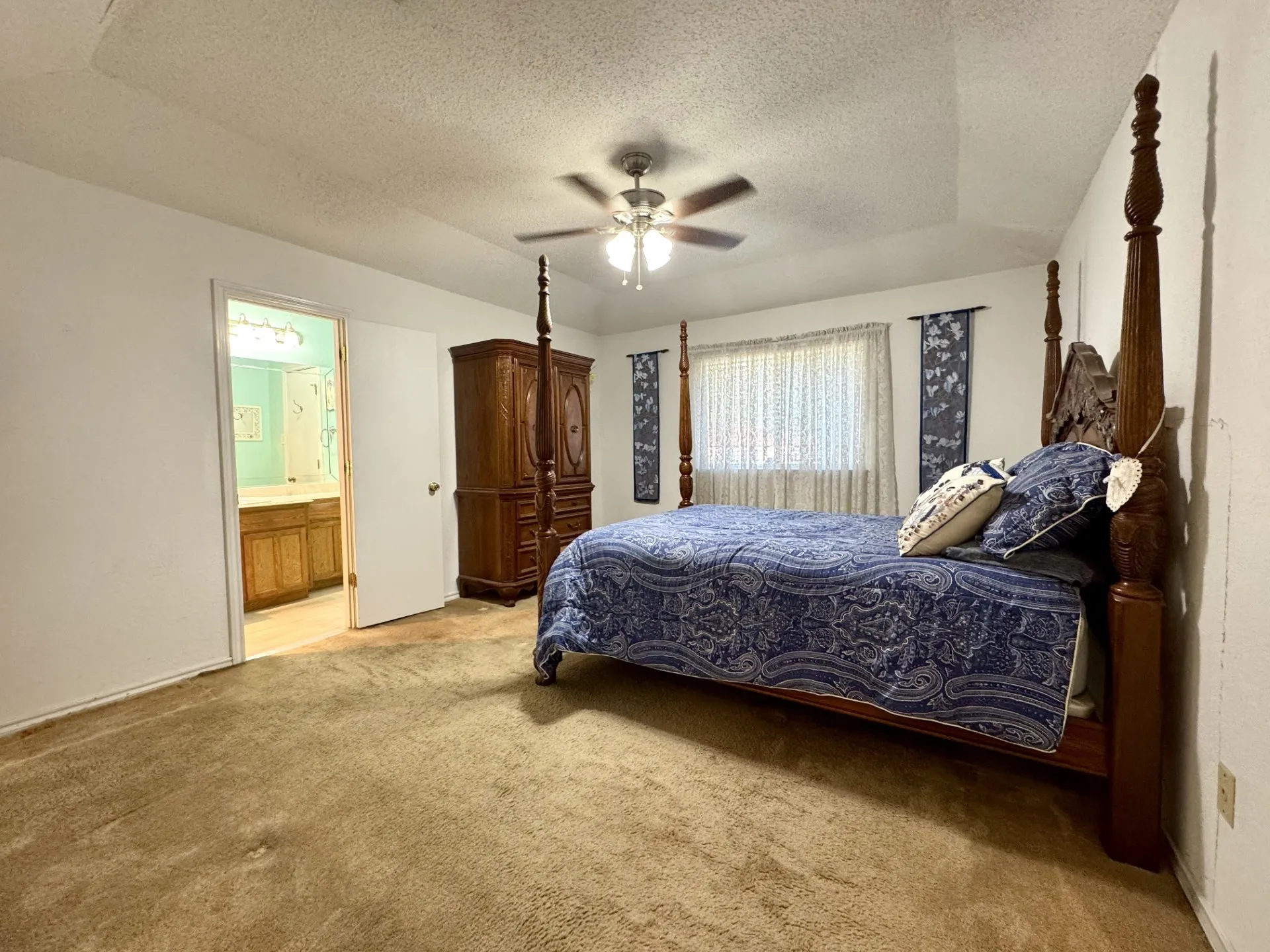 Spacious Primary Bedroom with Ensuite Bath is SPLIT from other bedrooms: vaulted ceiling with fan & carpeting (walk-in closet AND linen closet not shown).