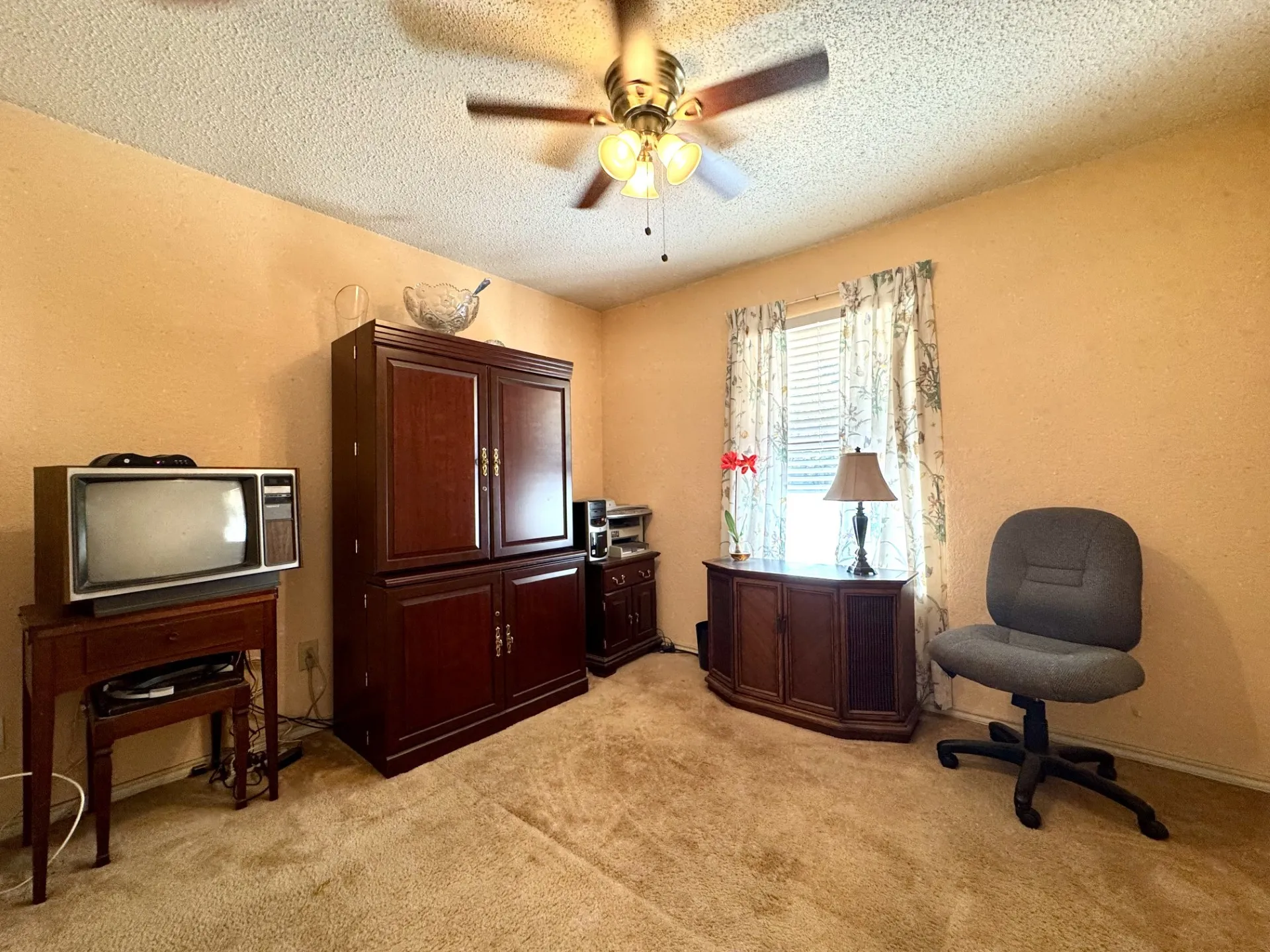 Front Bedroom 2 is SPLIT from Primary: closet, carpeting, and ceiling fan.