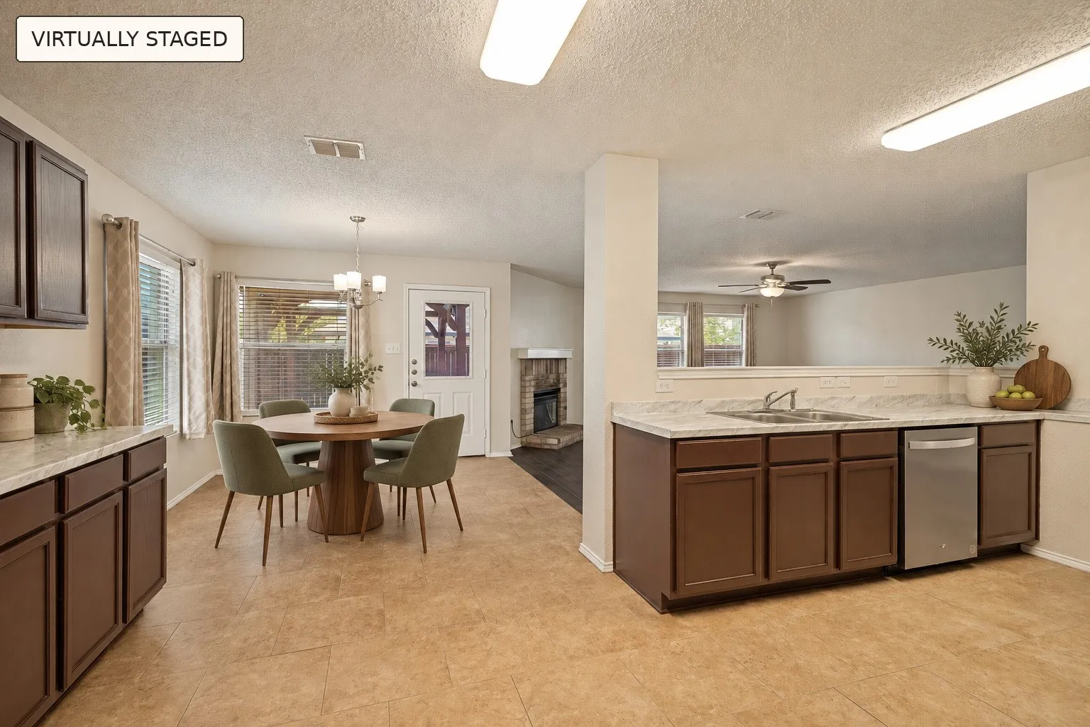 Kitchen featuring dark wood-finish cabinetry, white countertops, and a stainless steel dishwasher