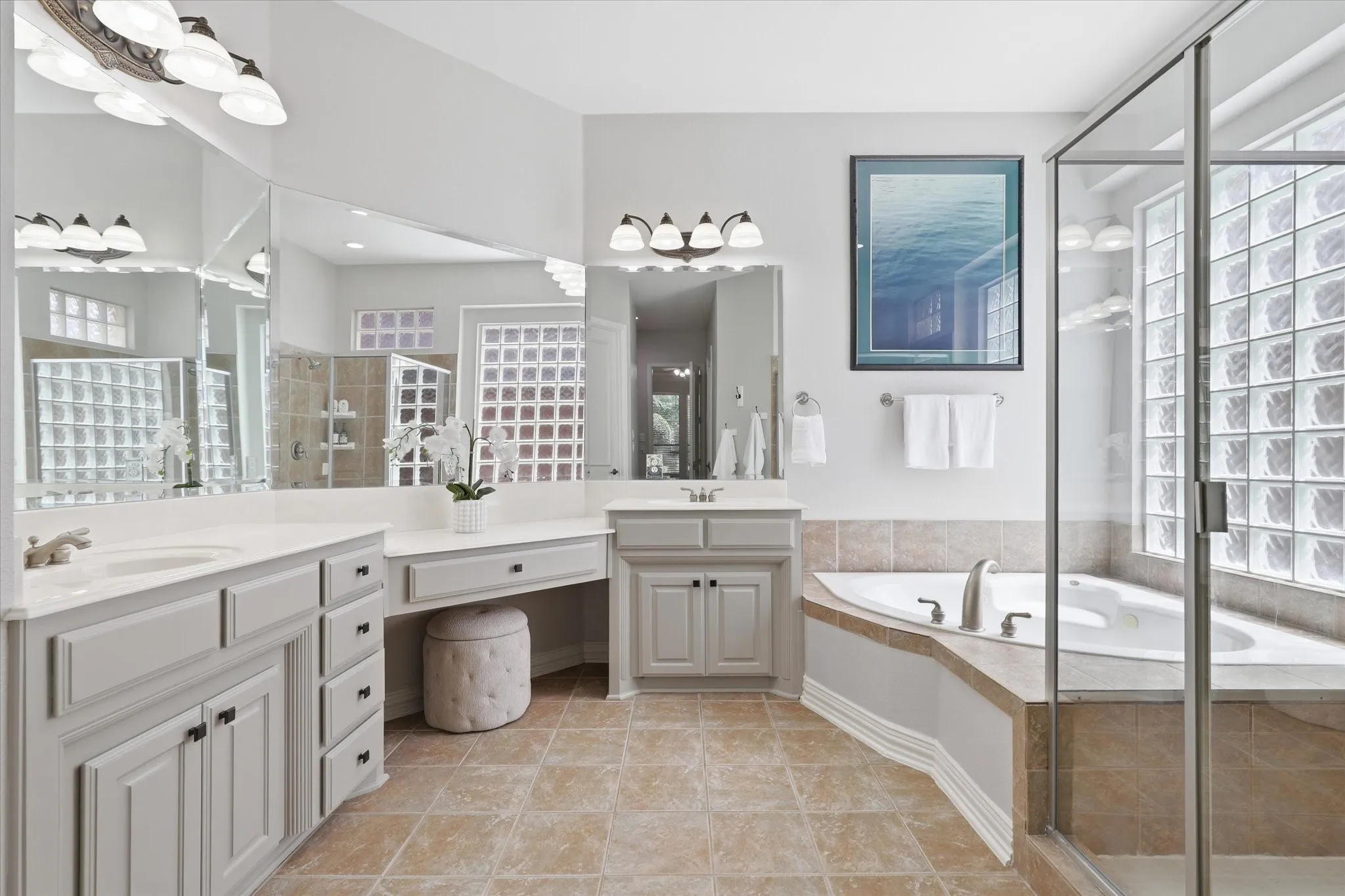 Dual sinks, a make-up area, separate shower and jetted tub complete the Primary Bath Room