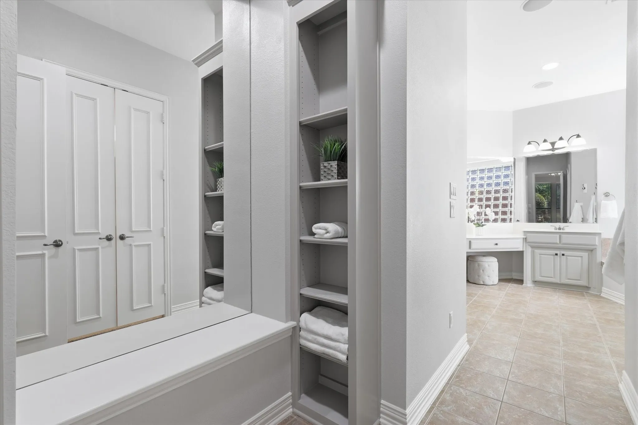 The Primary Bathroom includes a dressing area with a mirror and storage.