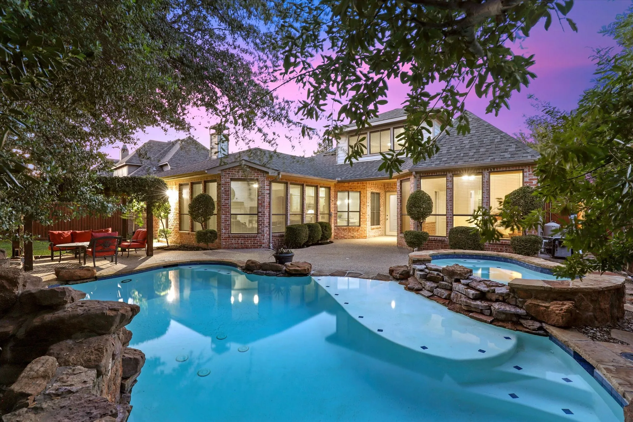 The backyard pool offers a sun deck and a hot tub.