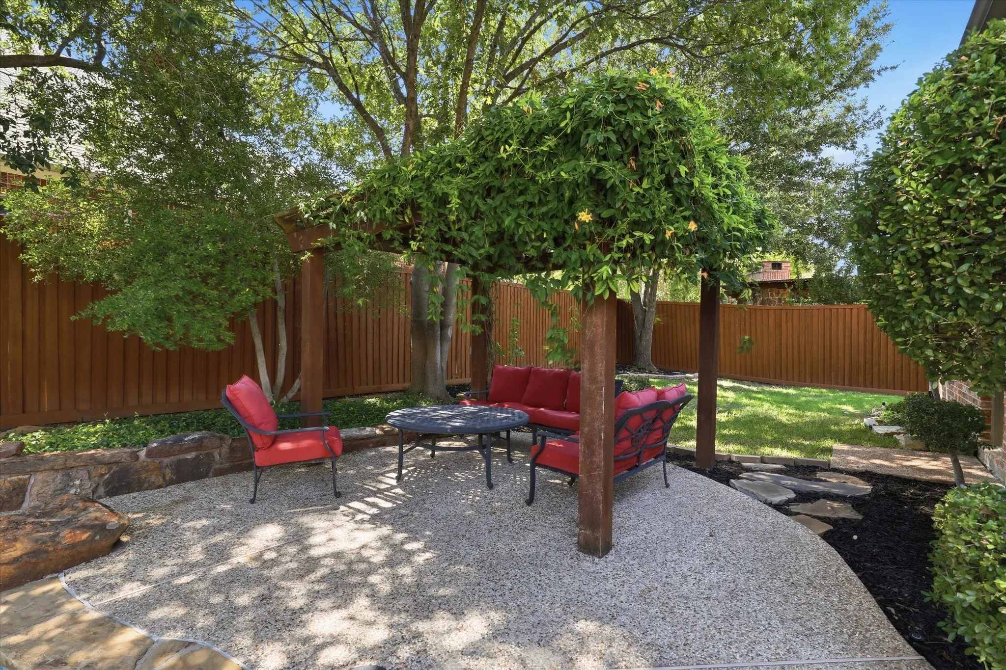 Shaded patio area under the arbor in the back yard