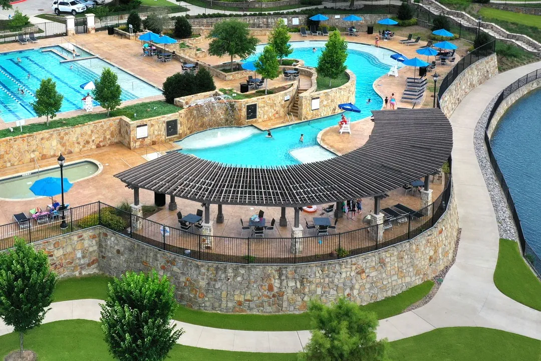 Community aquatic area featuring a lap pool, a leisure pool with a lazy river, and a dedicated wading pool