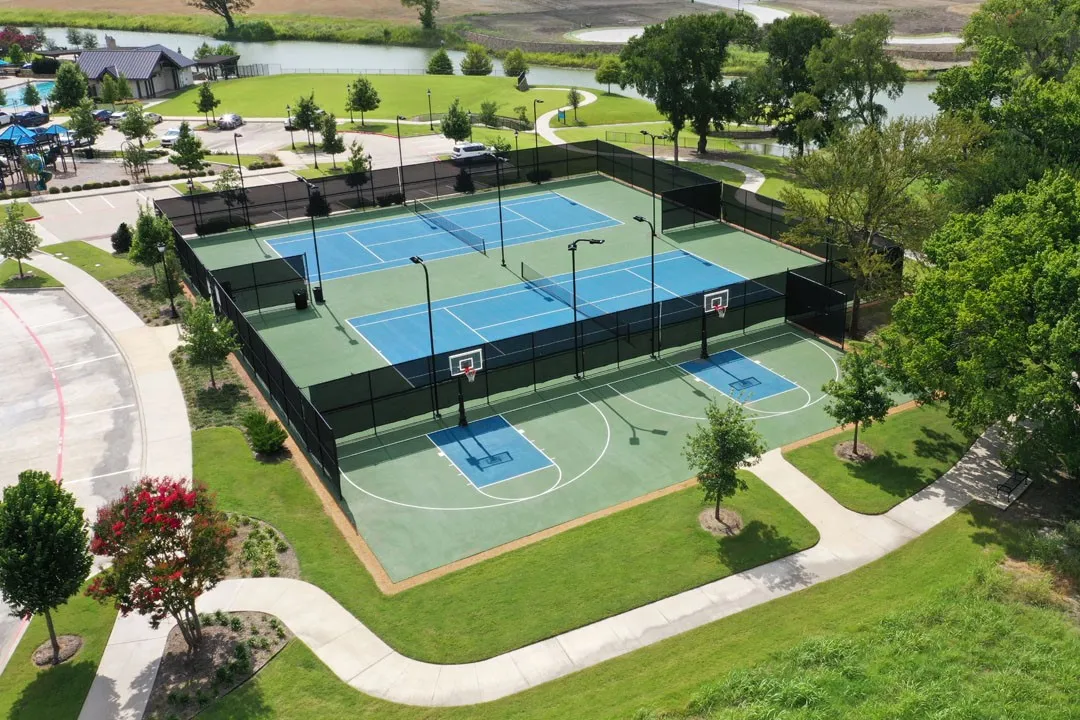 Premier recreational complex featuring four professional-grade tennis courts with hard court surfaces, integrated basketball court with regulation hoops, perimeter fencing, and LED lighting