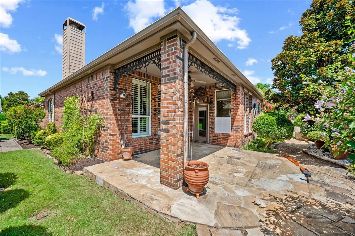 Rear extended flagstone covered patio with gardens all around