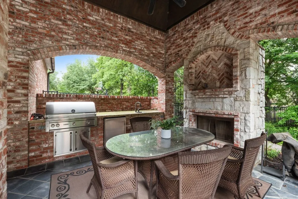 Patio with outdoor kitchen and fireplace