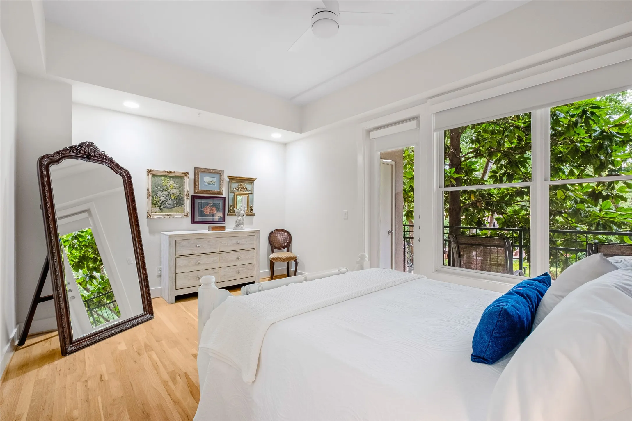 Hardwood flooring, recessed lighting, ceiling fan, expansive windows, and balcony access