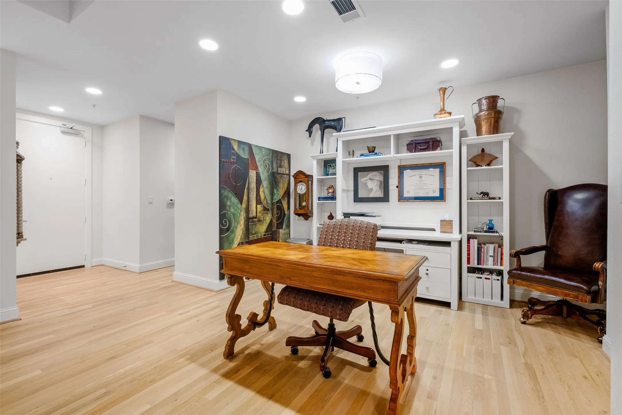 Light wood-finish flooring with recessed ceiling lights and a central flush-mount light