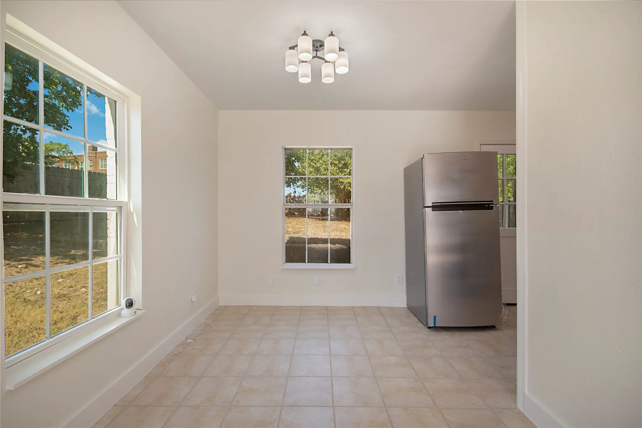 Recessed lighting, tile flooring, and white interior walls