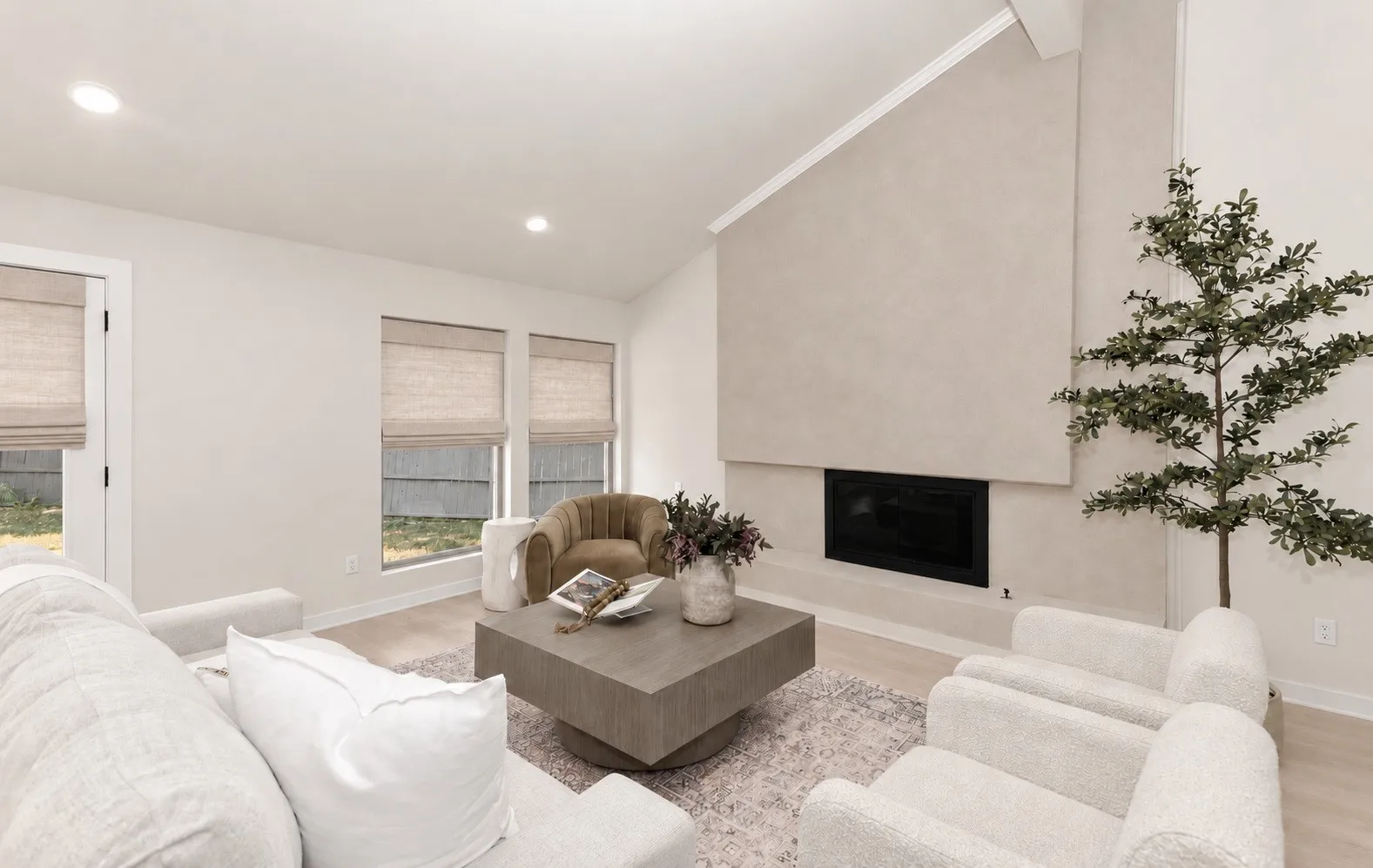 Vaulted ceiling with an integrated fireplace makes for entertaining and cozy conversation