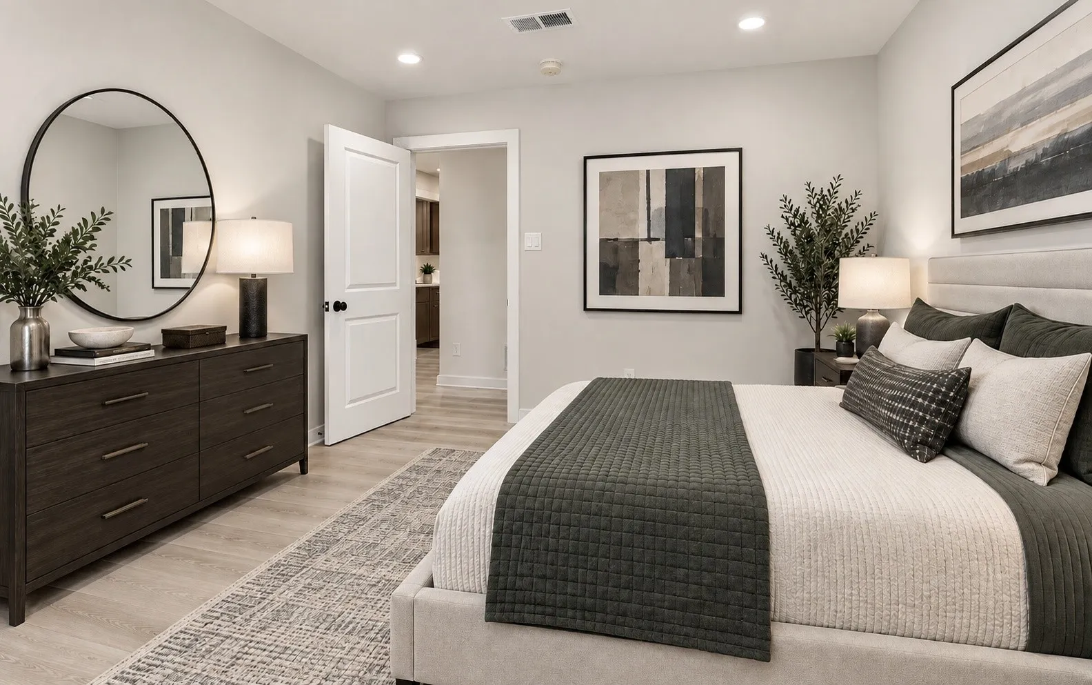 Bedroom 3 has recessed lighting illuminates the neutral wall tones and light wood-finish lpv flooring
