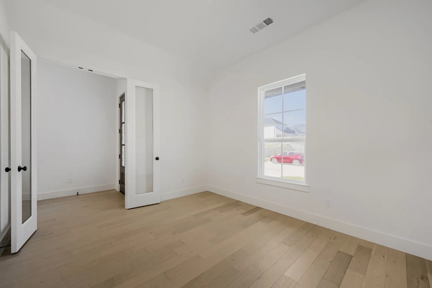 White walls with light wood-finish flooring