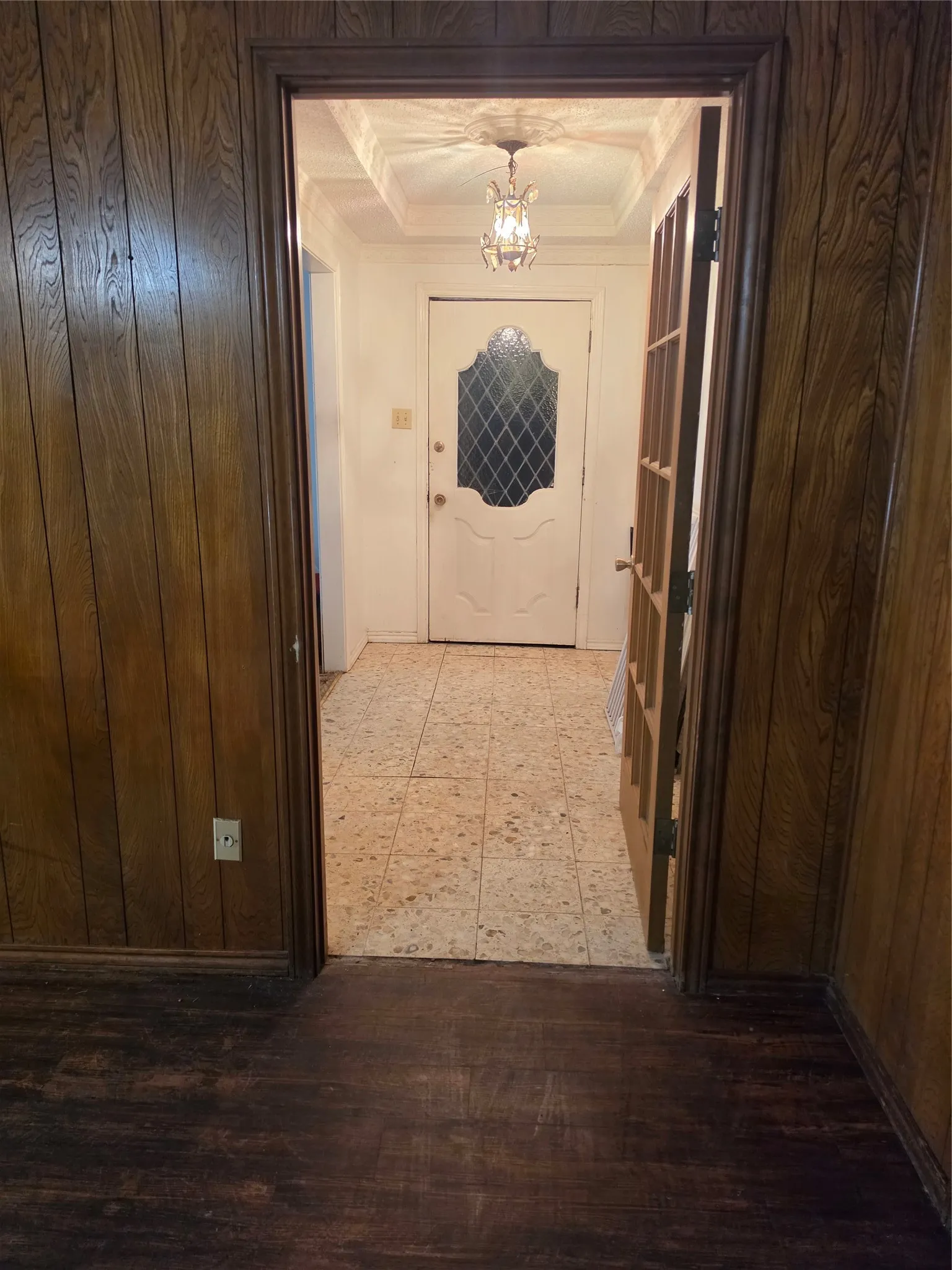 Wood-paneled walls and dark wood-finish flooring