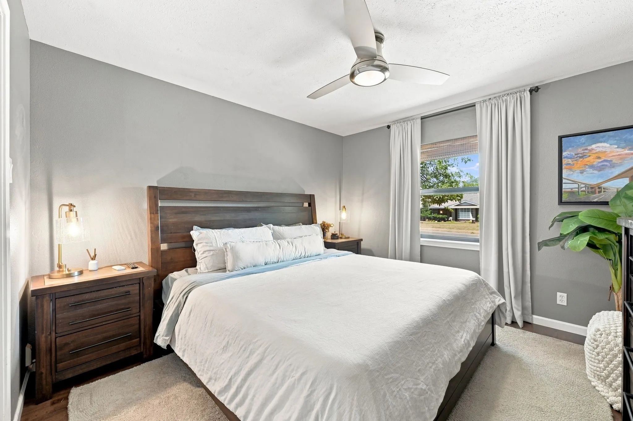 Secondary bedroom is spacious with a stylish ceiling fan