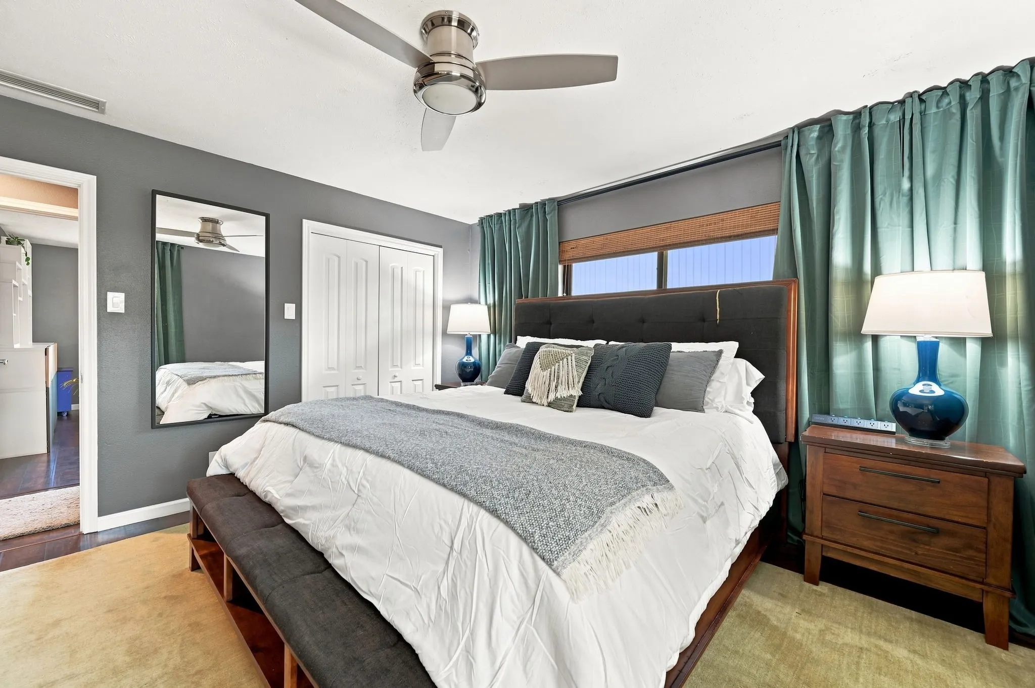 Designer ceiling fan and window shades.