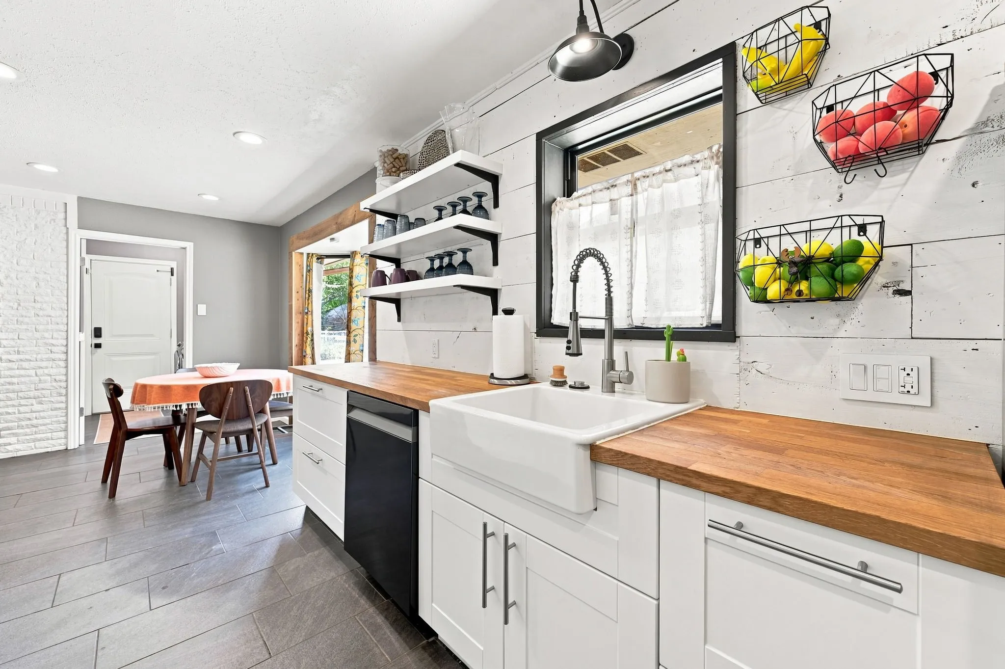 Apron farmhouse sink & sleek black hardware elevate this space.