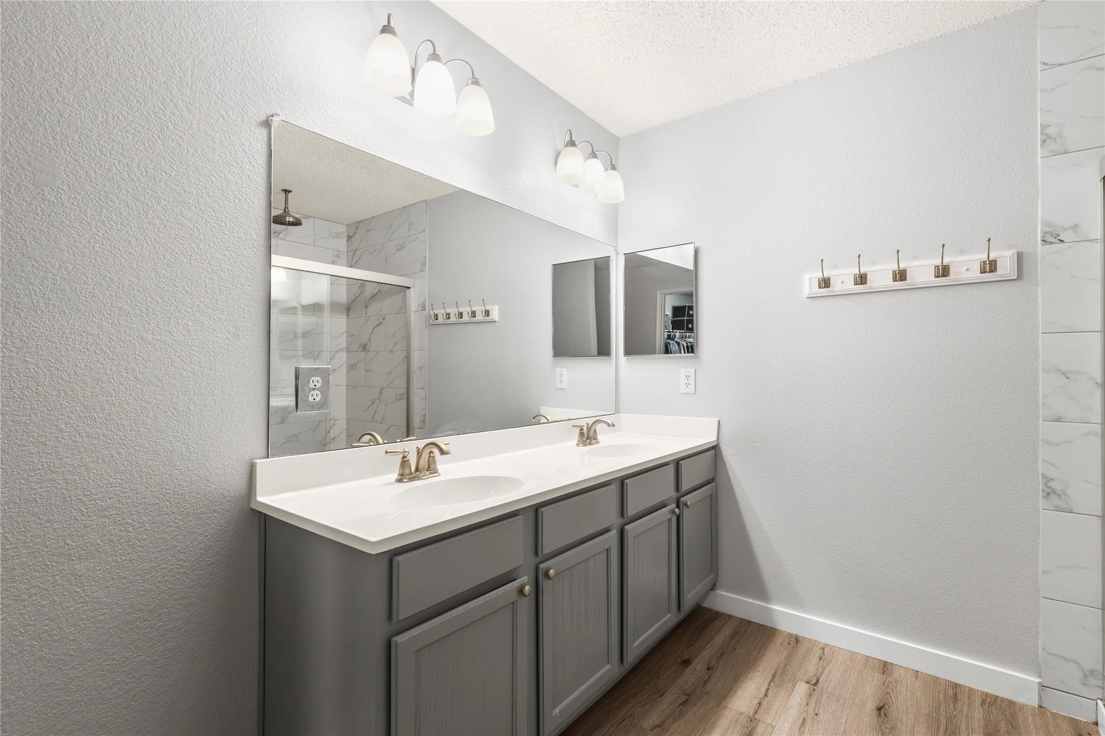 Dual vanity with white countertops, undermount sinks, and brushed nickel fixtures
