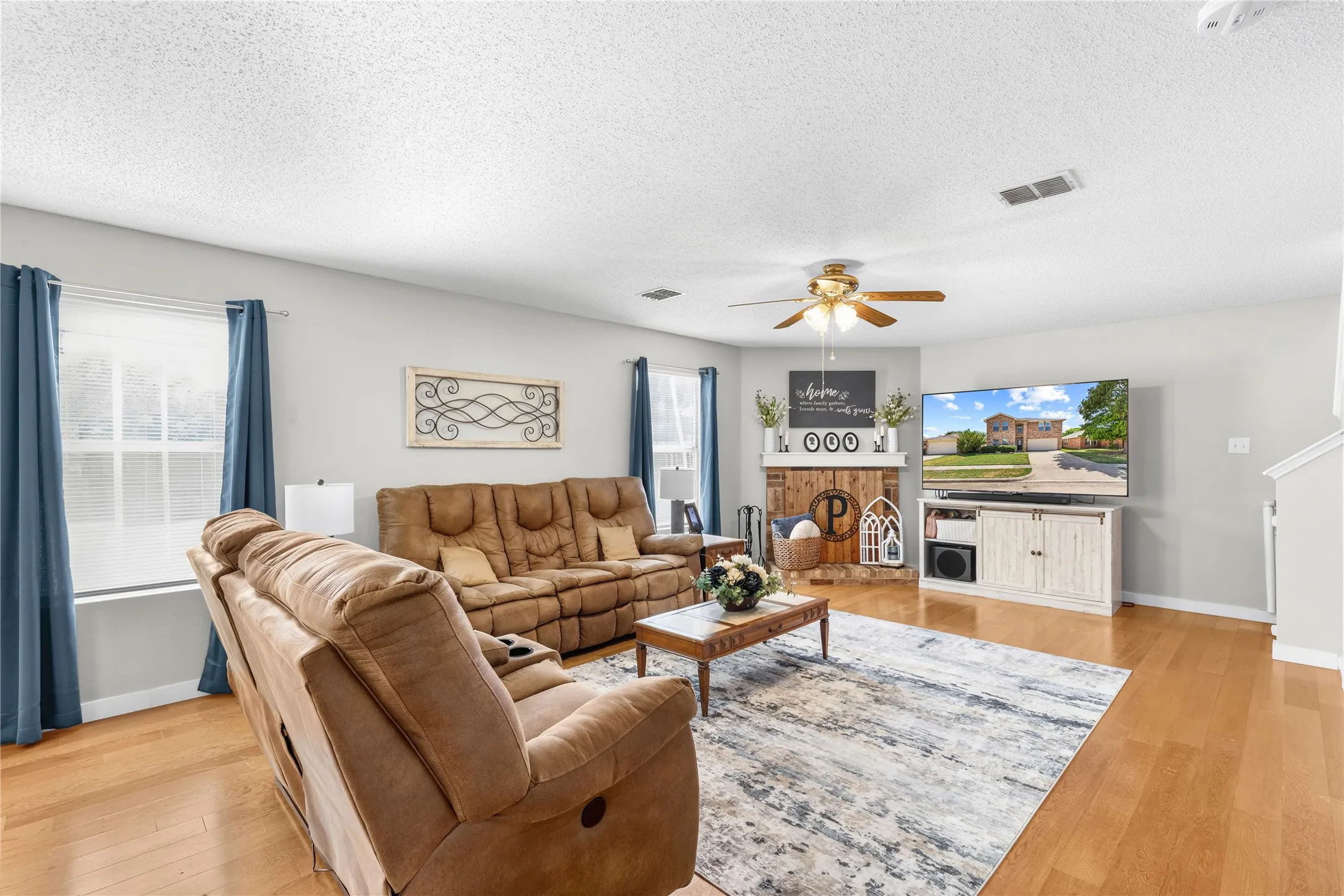 Light-toned wood-finish flooring complements light gray walls
