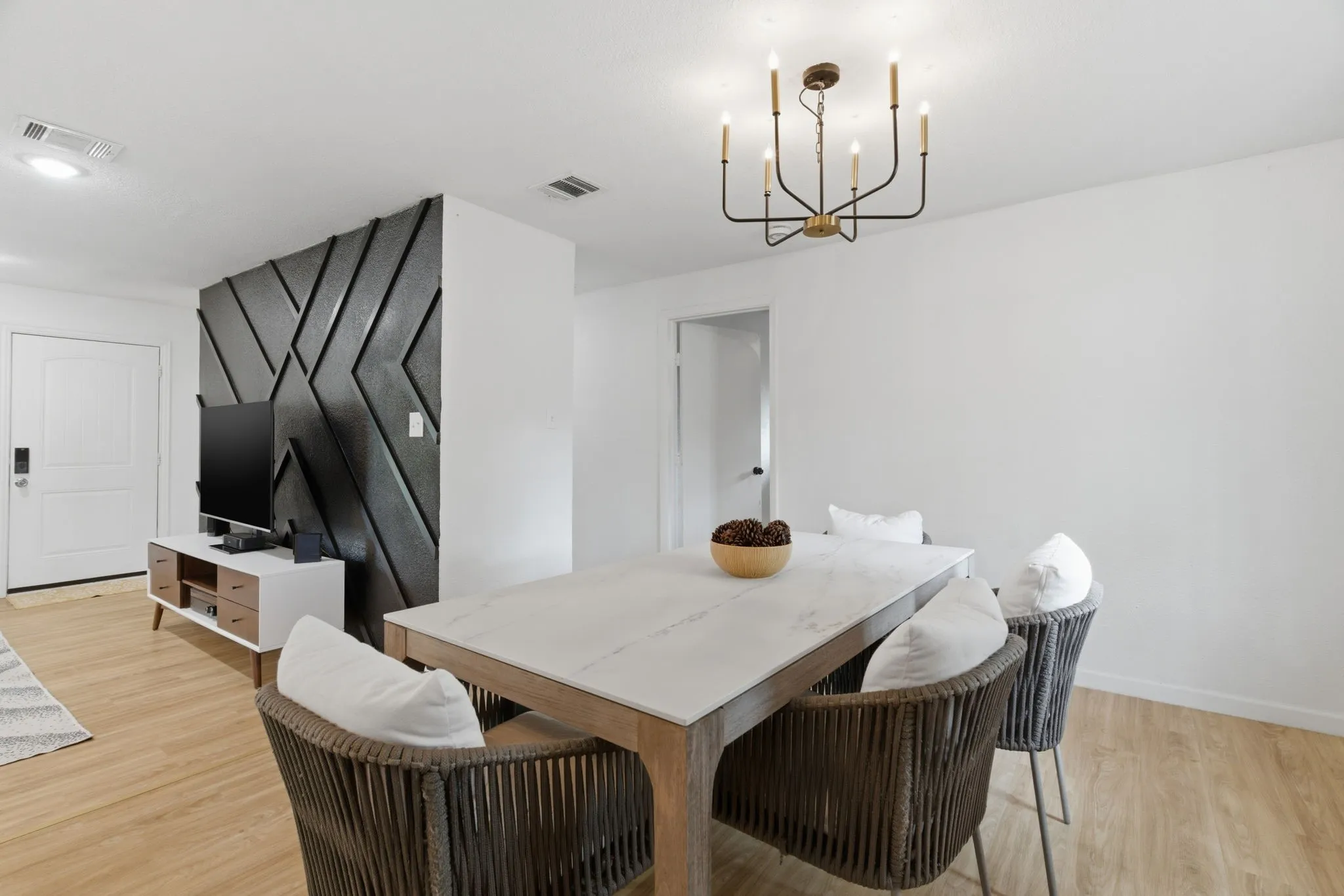 Dining space featuring light wood-type flooring and suspended lighting
