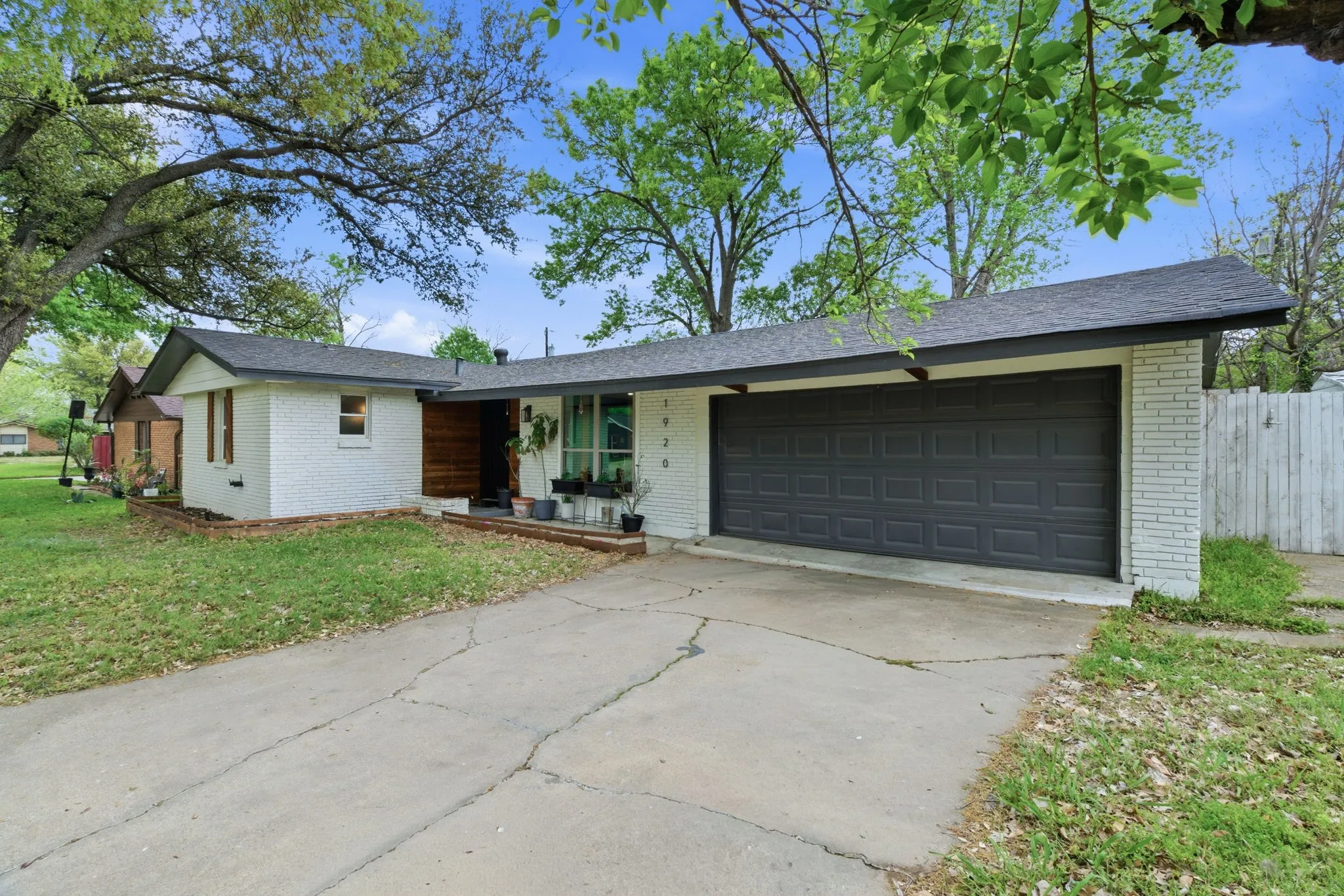 Ranch-style home with brick siding, concrete driveway, and an attached garage