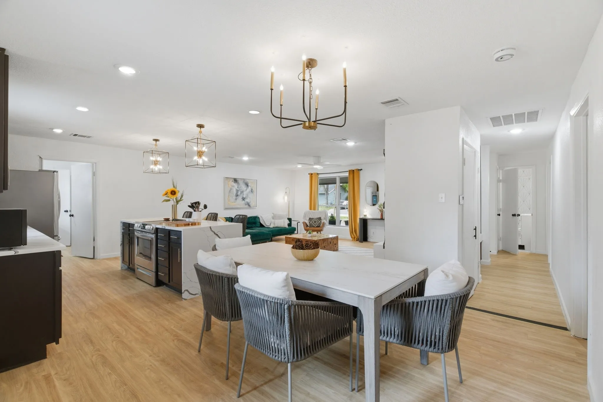 Dining area with hanging lights and light wood-type flooring