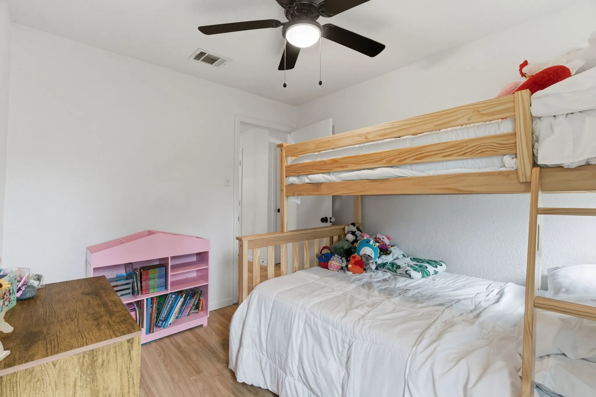 Bedroom with ceiling fan and light wood-style floors