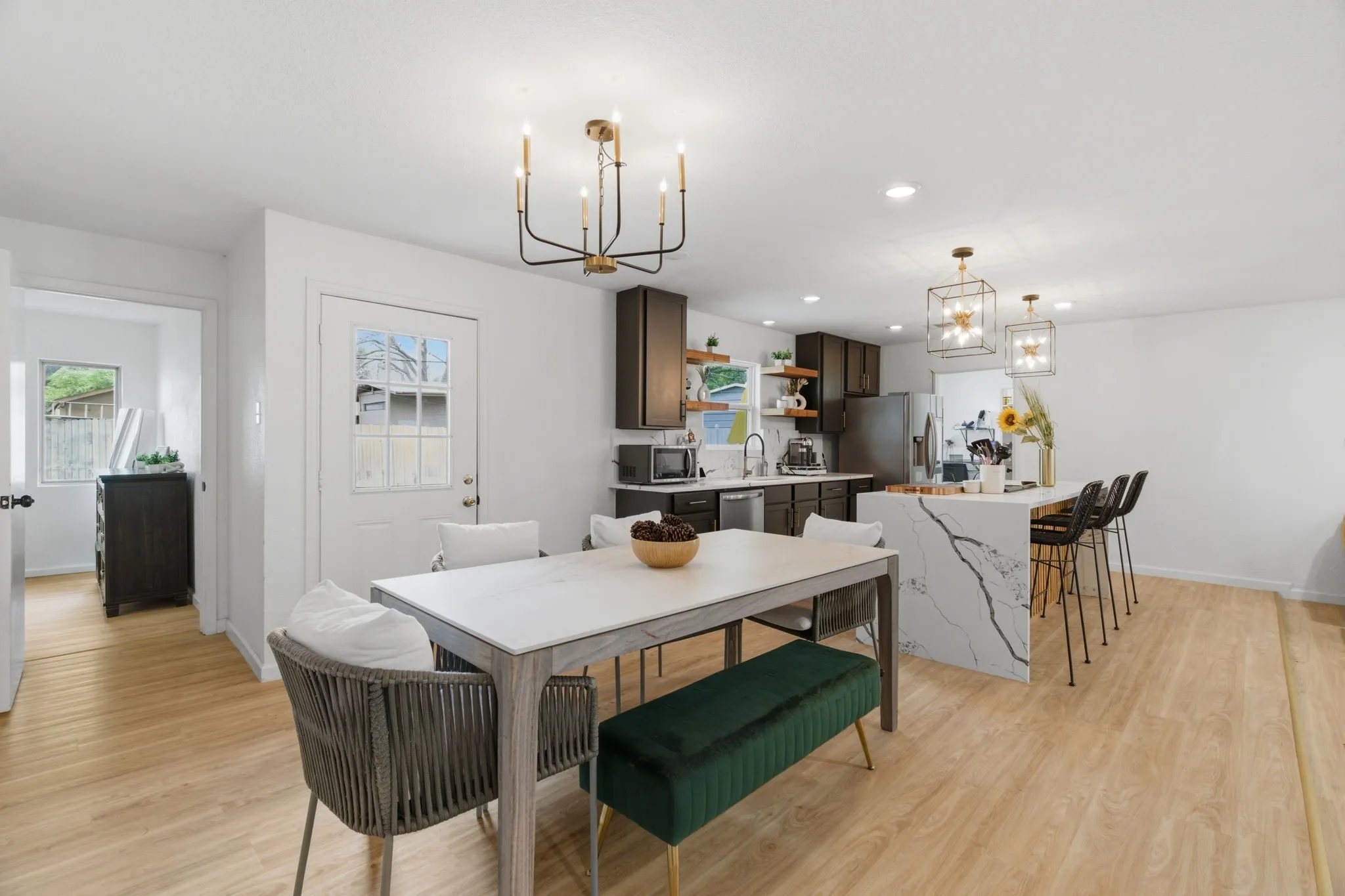 Dining room featuring light wood-style floors and hanging lights