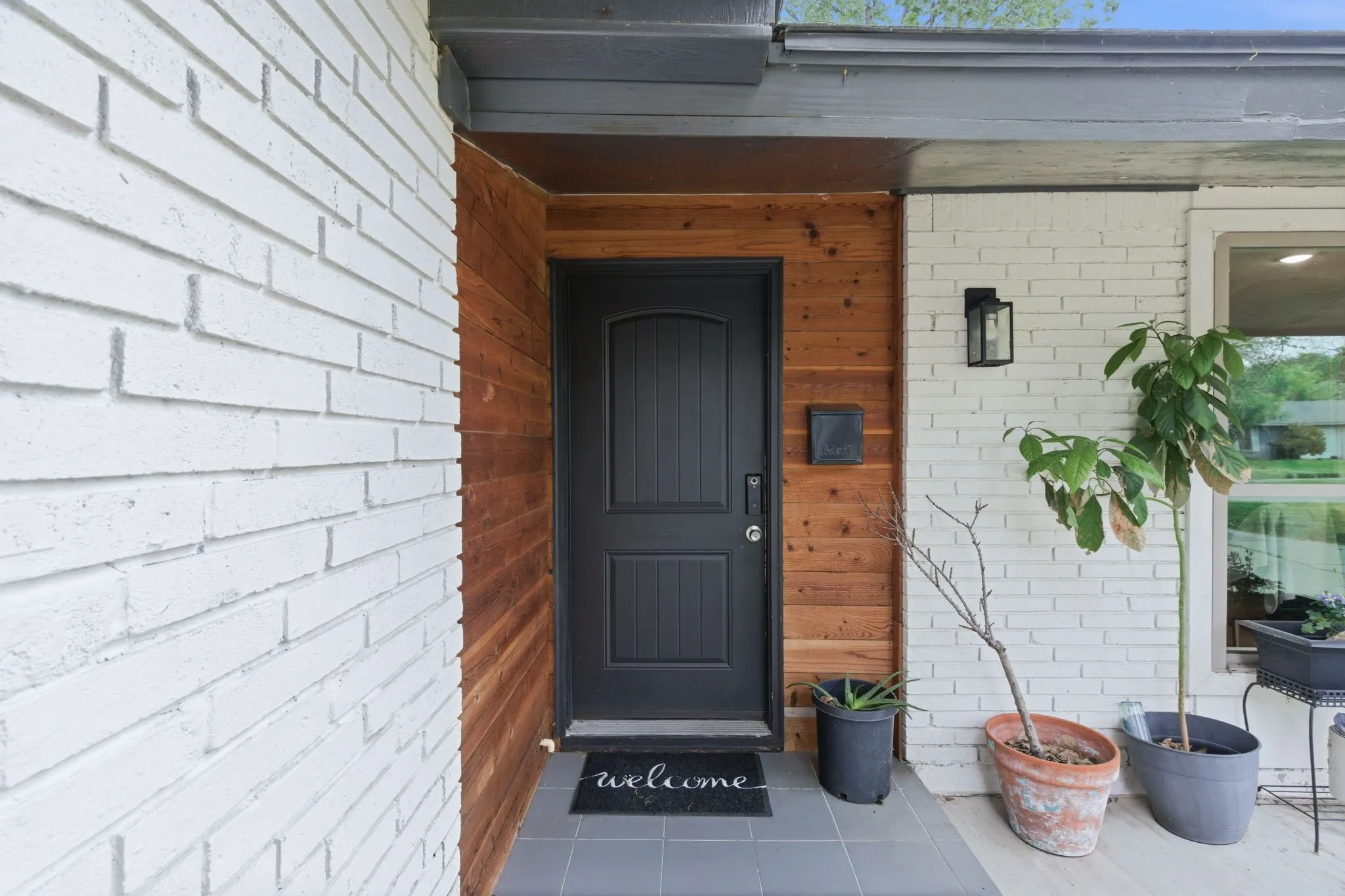View of exterior entry with brick siding