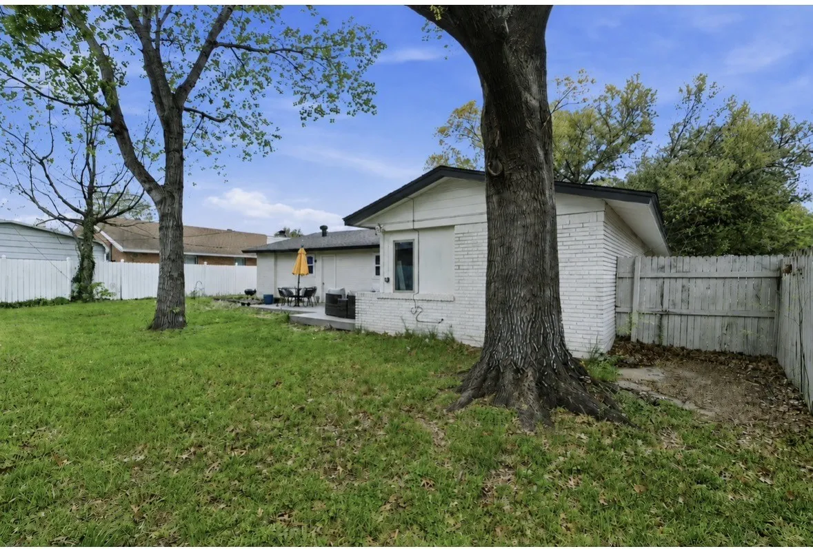 Spacious single-story home situated on a generous lot with mature shade trees and lush lawn