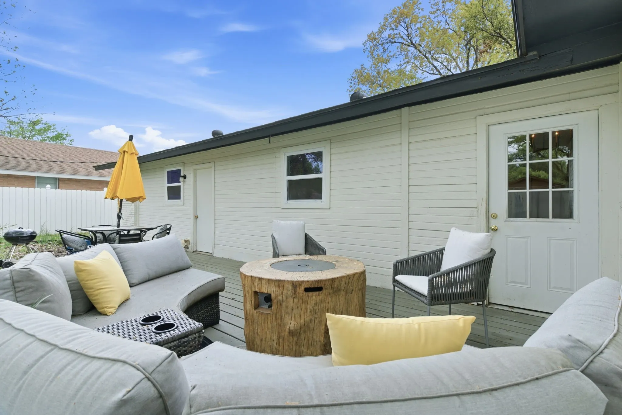 Deck with an outdoor living space with a fire pit