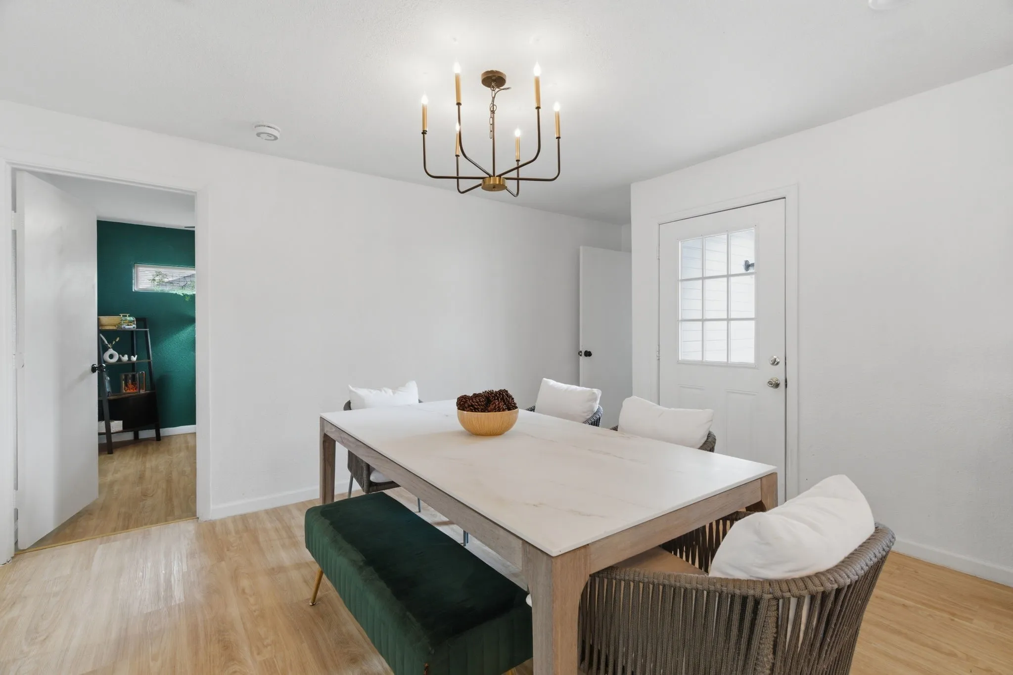 Dining space with light wood finished floors and suspended lighting