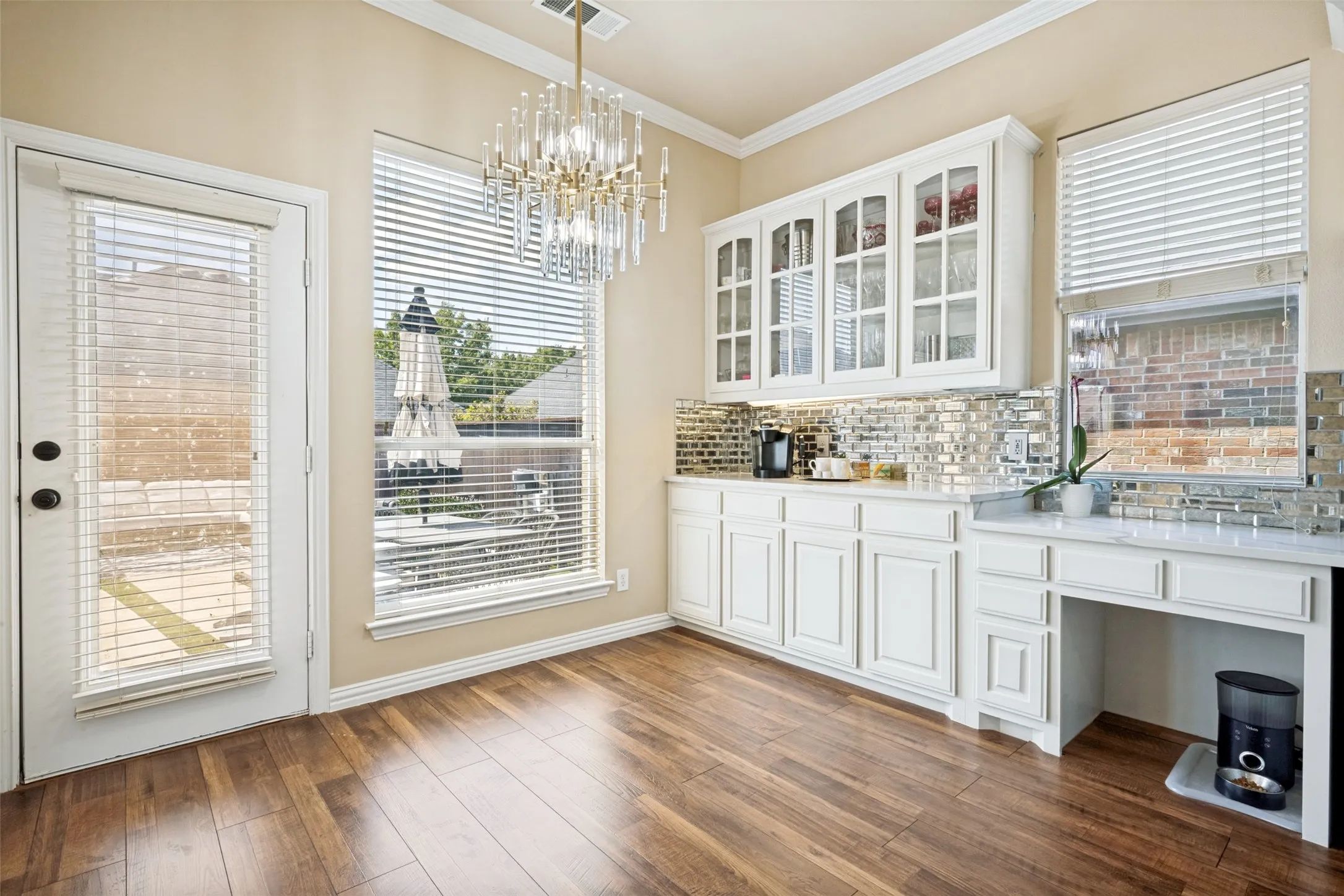Breakfast area with banquet and cabinets. A great spot for your beverage center.