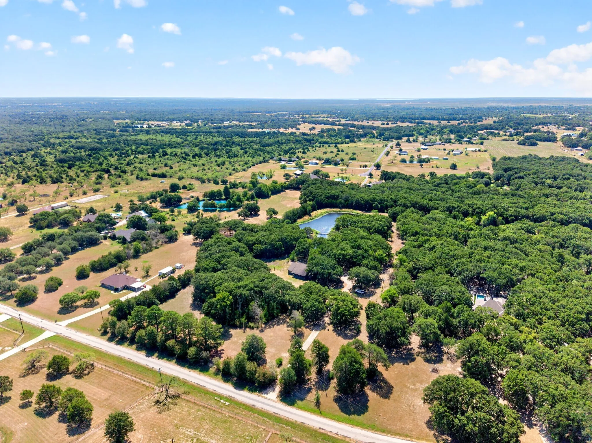Expansive treed landscape with multiple homesites and a private pond