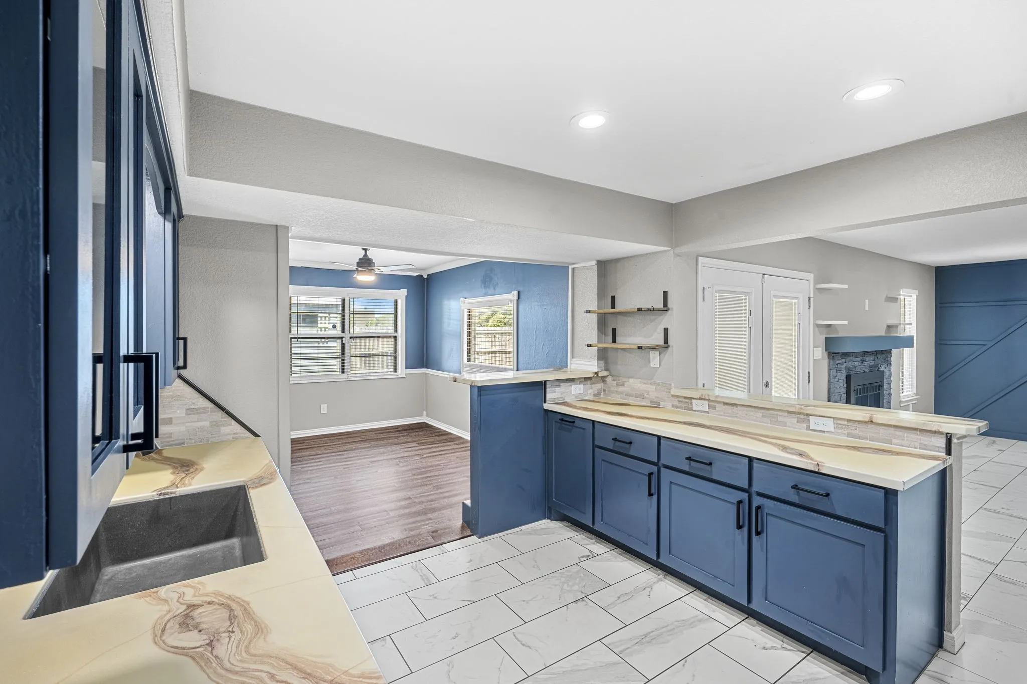 Modern kitchen with blue cabinetry and light-toned countertops