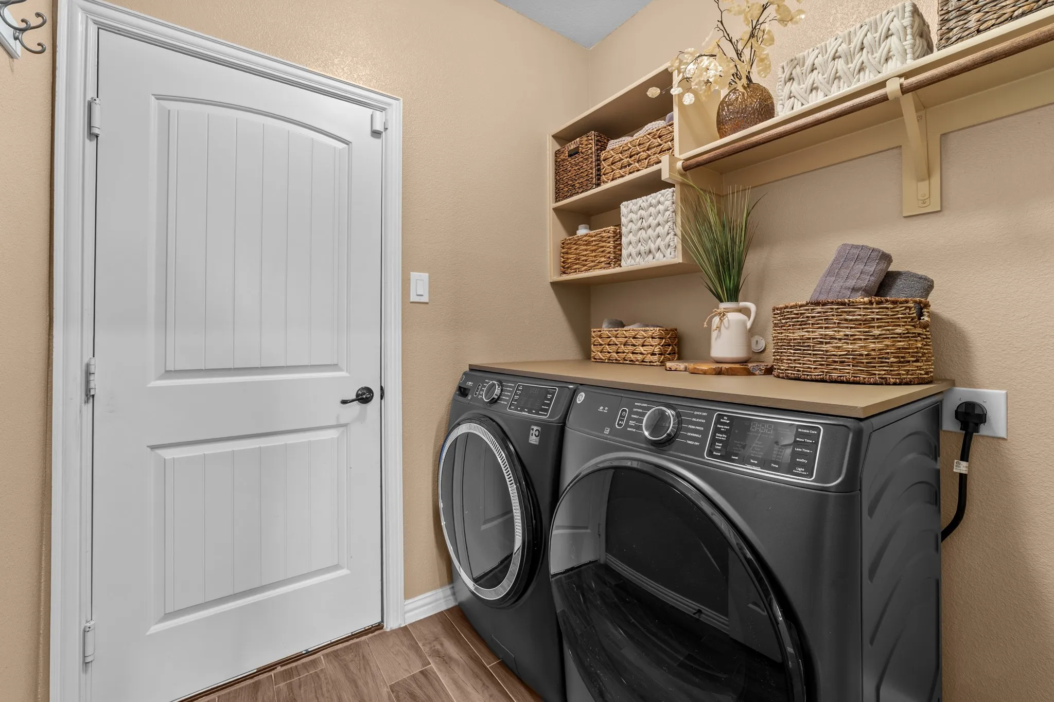 Dedicated laundry room featuring wood-look tile flooring throughout
