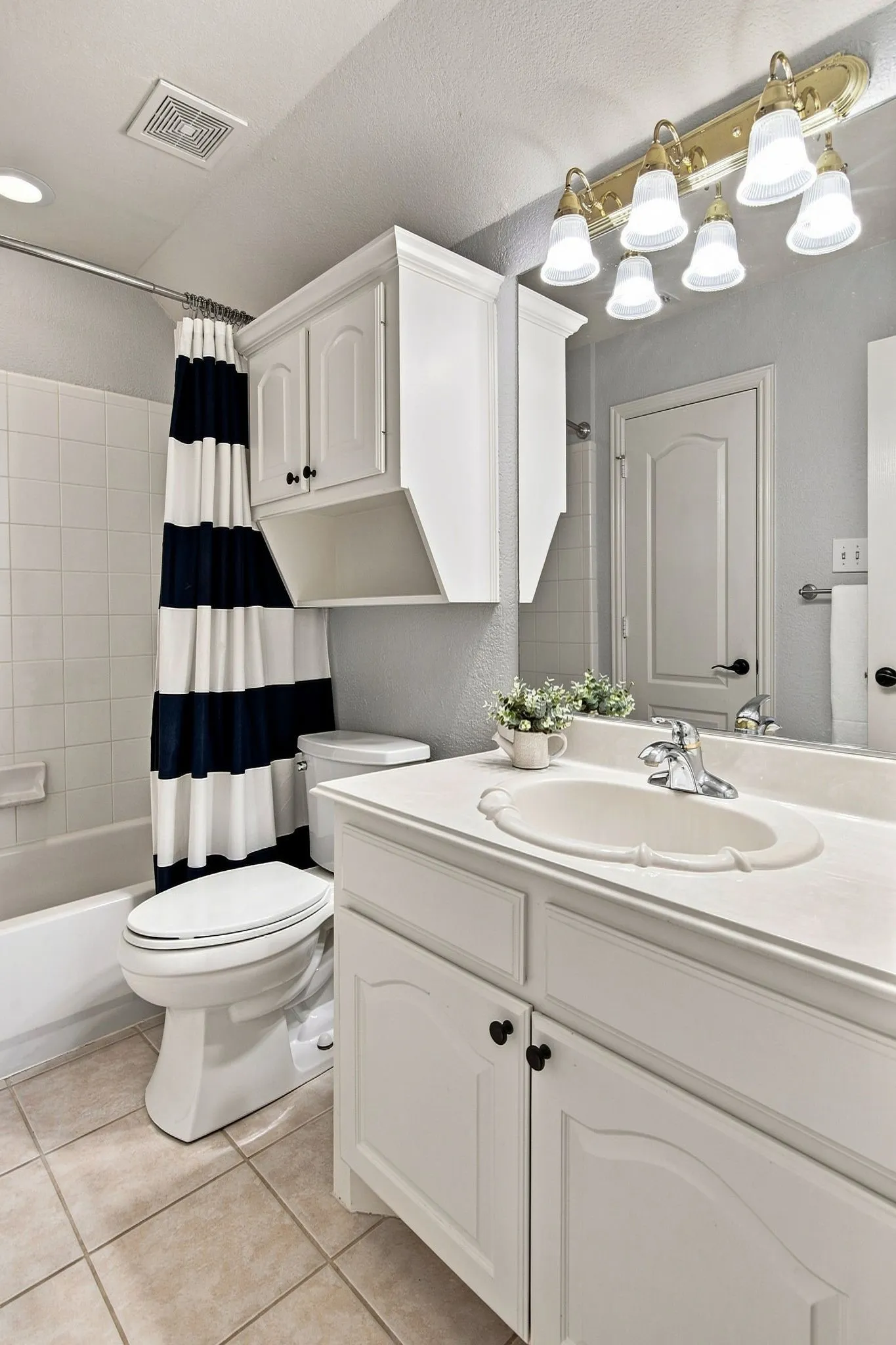 Spa-inspired bathroom showcasing a white vanity with dual-sink configuration, polished chrome faucetry, and ample storage