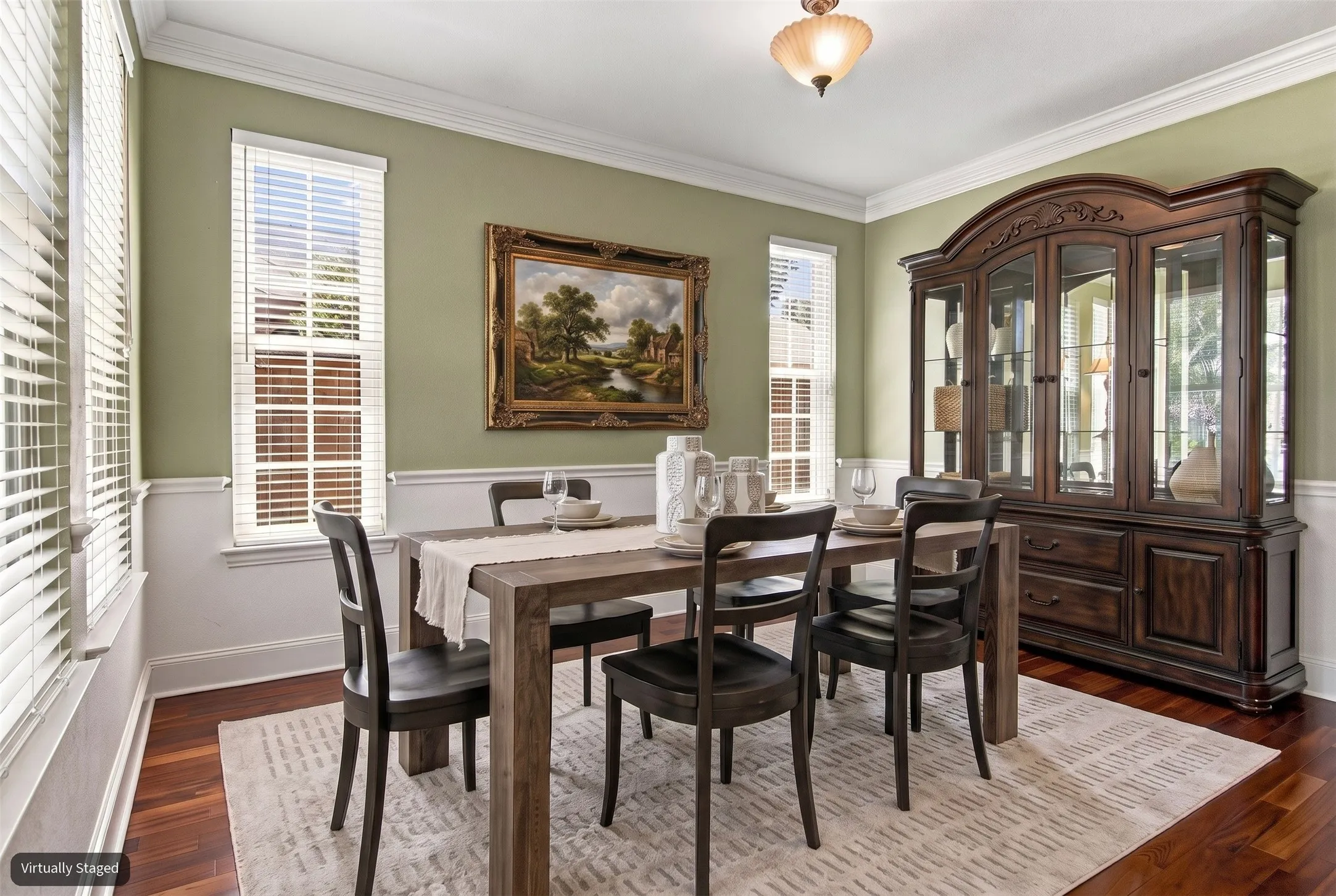 Hardwood flooring, crown molding, chair rail, multiple windows with blinds, and a built-in ceiling fixture