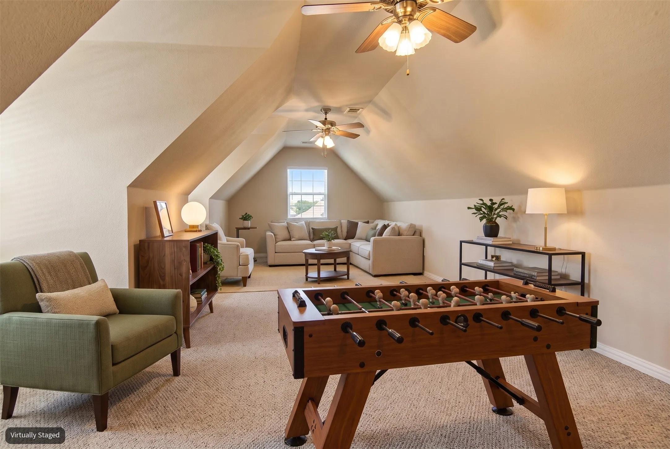 Carpeted loft space featuring sloped ceilings, multiple ceiling fans, and a window