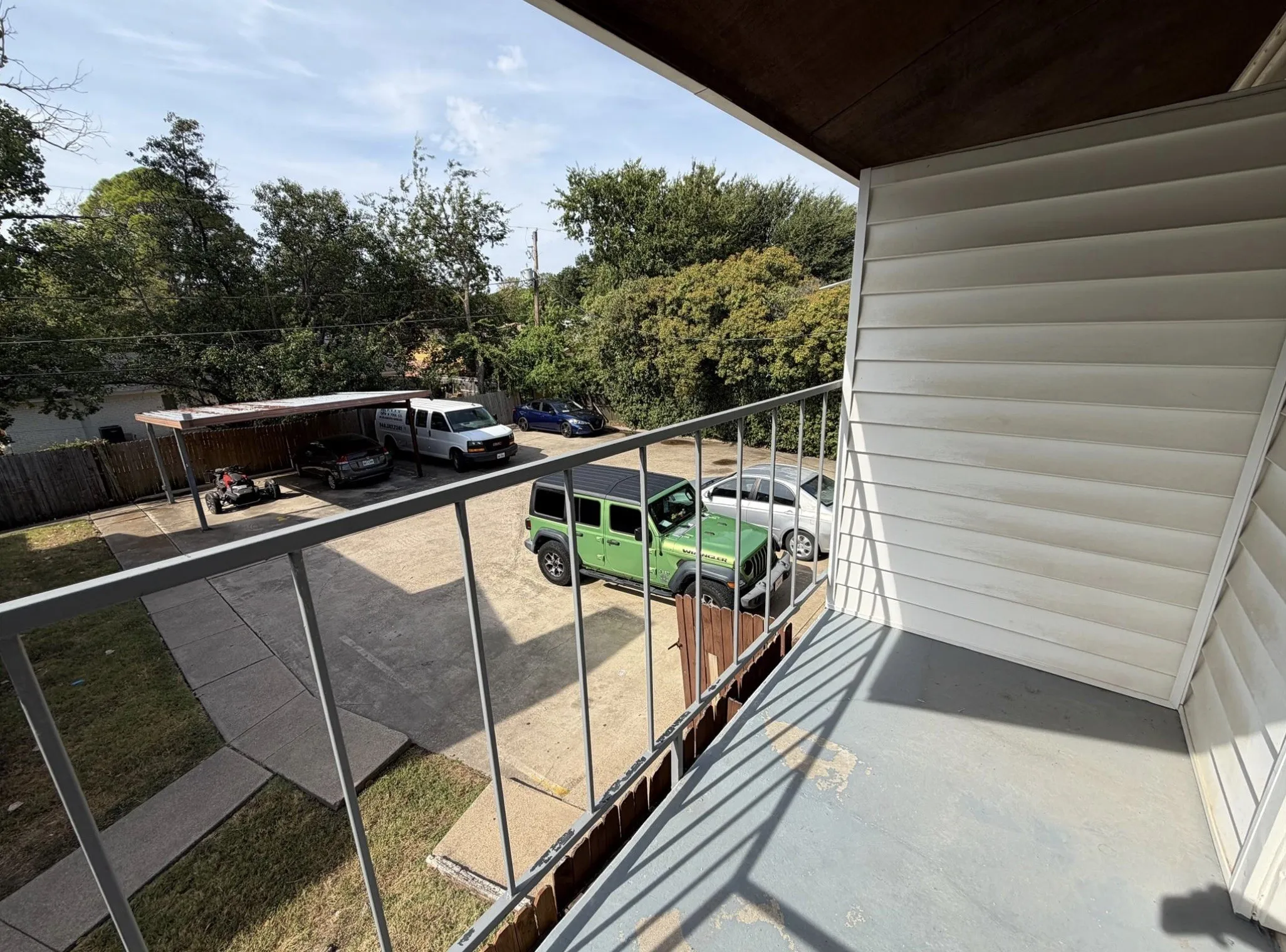 Balcony with metal railing and vinyl siding