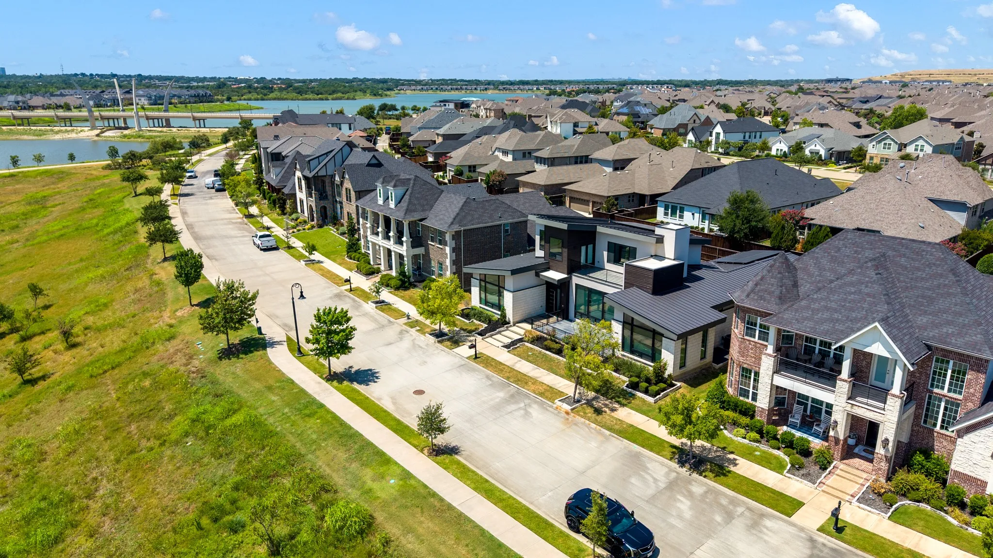 Prestigious estate-style home anchoring a manicured streetscape within a planned community