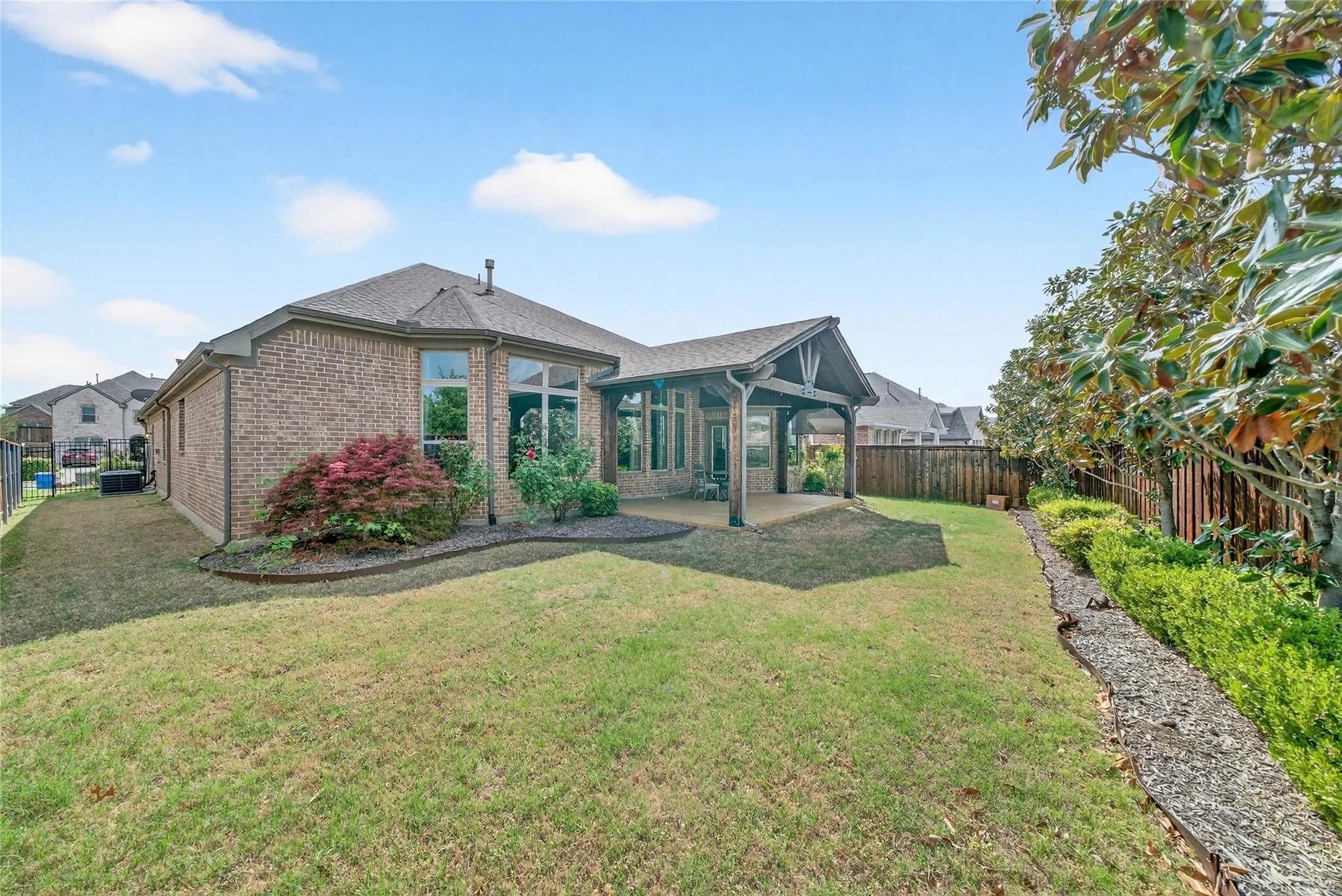 Brick exterior with gabled roofline and covered porch entry featuring glass paneling