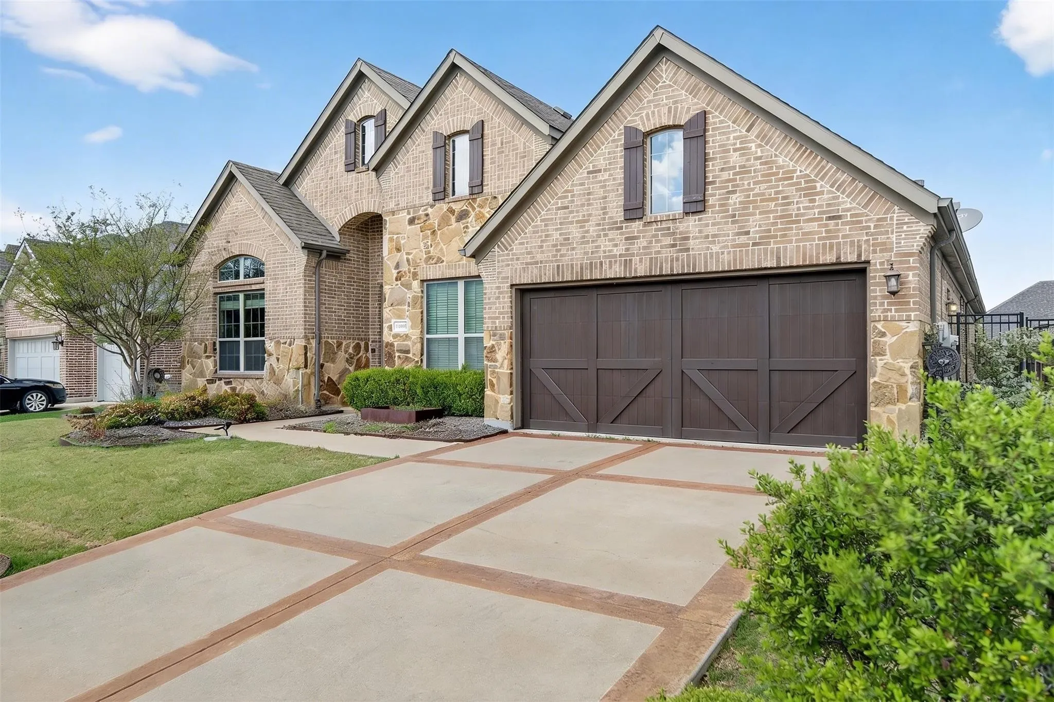 Elegant brick and stone exterior featuring multiple gables and architectural detail